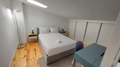 a small bedroom with a bed and a window at Gaia Apartments by the Wine Cellars in Vila Nova de Gaia