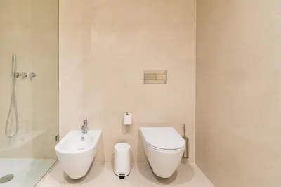 a bathroom with a toilet and a sink at Bonjardim Suites in Porto