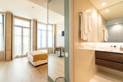 a bathroom with a sink and a mirror at Bonjardim Suites in Porto