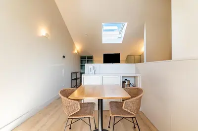 a dining room with a wooden table and chairs at Bonjardim Suites in Porto