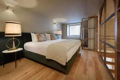 a bedroom with a large bed and a window at Condes de Azevedo Palace Apartments in Porto