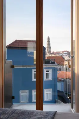 a view of a blue building from a window at Condes de Azevedo Palace Apartments in Porto