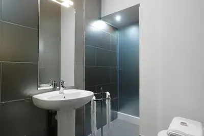 a bathroom with a sink and a shower at Almond Biscuit Porto Historic Center in Porto
