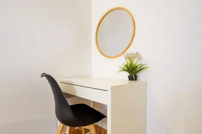 a white desk with a mirror and a black chair at Porto Covelo Park Apartment in Porto