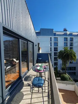 a patio with a table and chairs on a balcony at Bonjardim Bright Studio in Porto