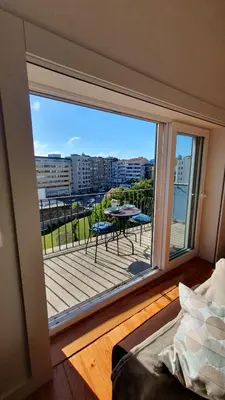 a room with a balcony with a table and a view at Bonjardim Bright Studio in Porto