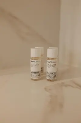 two bottles of medication sitting on a white floor at Bolhão Downtown in Porto