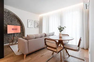 a living room with a couch and a table at GuestReady - Crown Garden Escape in Porto