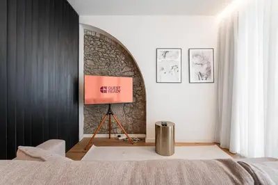 a bedroom with a bed and a painting on a wall at GuestReady - Crown Garden Escape in Porto