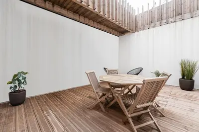 a dining room with a wooden table and chairs at GuestReady - Crown Garden Escape in Porto