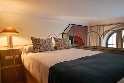 a bedroom with a bed with a lamp and a window at Aliados 9 - Luxury in the Heart of Porto in Porto