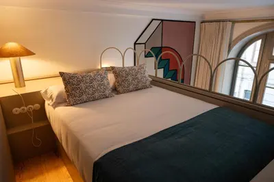 a bedroom with a large bed with a window at Aliados 9 - Luxury in the Heart of Porto in Porto