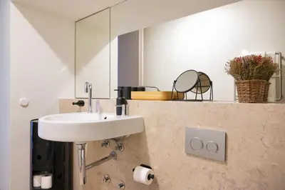 a bathroom with a sink and a mirror at Aliados 9 - Luxury in the Heart of Porto in Porto