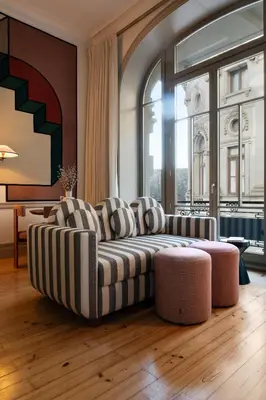 a living room with a couch and a large window at Aliados 9 - Luxury in the Heart of Porto in Porto
