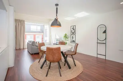 a living room with a dining room table and chairs at Liiiving in Porto - Luxury Gallery Apartment I in Porto