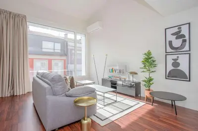 a living room with a couch and a tv at Liiiving in Porto - Luxury Gallery Apartment I in Porto