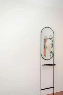 a mirror on a stand next to a wall at Liiiving in Porto - Luxury Gallery Apartment I in Porto