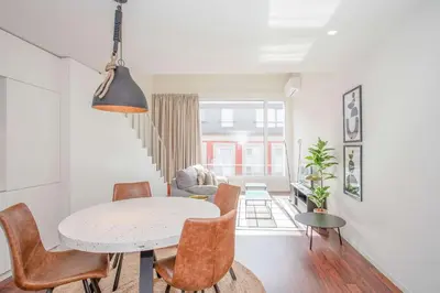 a dining room and living room with a table and chairs at Liiiving in Porto - Luxury Gallery Apartment I in Porto