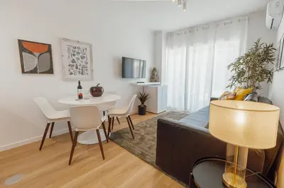 a living room with a table and a dining room at Cozy Bonfim by Hosty in Porto