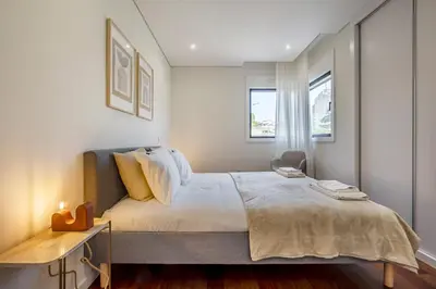 a bedroom with a large bed and a window at Nomad's Lux - 2bdr & Parking Flores Square Porto in Porto