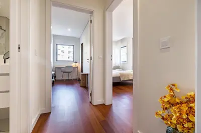 a hallway with a bedroom and a bed in a room at Nomad's Lux - 2bdr & Parking Flores Square Porto in Porto