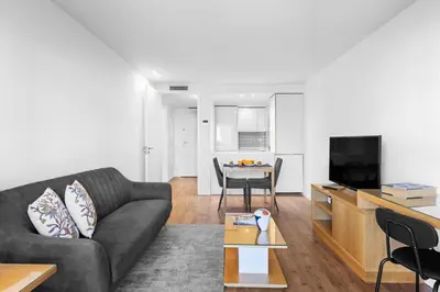 a white room with a bedroom and a bed at Bright Apartment with Balcony & Parking | Bonfim in Porto
