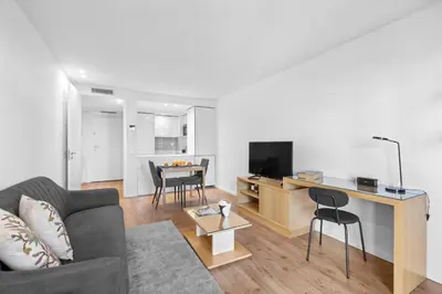 a kitchen and living room with white cabinets at Bright Apartment with Balcony & Parking | Bonfim in Porto