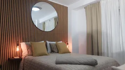 a bedroom with a bed with a large mirror at Elegance in Porto in Porto