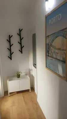 a living room with a table and a picture on the wall at Elegance in Porto in Porto