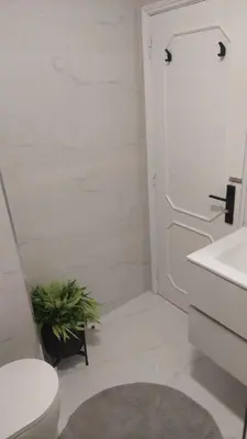 a bathroom with a toilet and a sink and a plant at Elegance in Porto in Porto