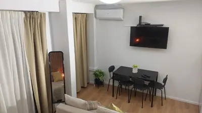 a living room with a black table and chairs at Elegance in Porto in Porto
