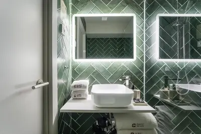 a bathroom with a sink and a mirror at GuestReady - The Cats Studios in Porto