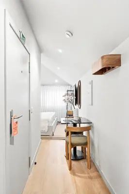 a room with a desk and a table with a chair at GuestReady - The Cats Studios in Porto