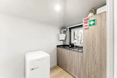 a small kitchen with a sink and a refrigerator at GuestReady - The Cats Studios in Porto
