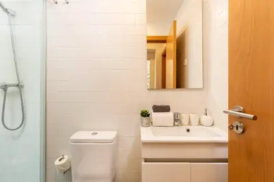 a bathroom with a toilet and a sink and a shower at YOUROPO - Cosy in Porto