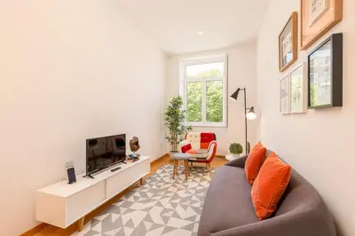 a living room with a couch and a tv at YOUROPO - Cosy in Porto