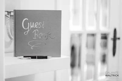 a sign with the words guest book on a shelf at 2Bedroom Flat - Families, remote work, downtown - Private Garage in Porto