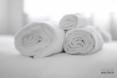 two rolls of white towels sitting on a table at 2Bedroom Flat - Families, remote work, downtown - Private Garage in Porto