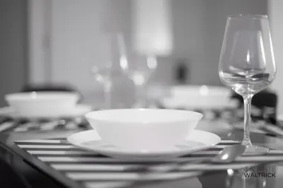a table with a plate and a wine glass at Quiet 3BR Flat - City Center - Warm and Bright - Remote Work in Porto