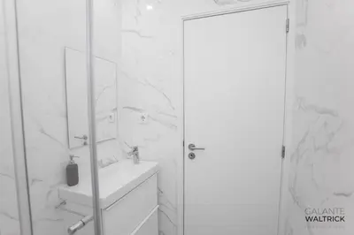 a white bathroom with a sink and a mirror at Quiet 3BR Flat - City Center - Warm and Bright - Remote Work in Porto