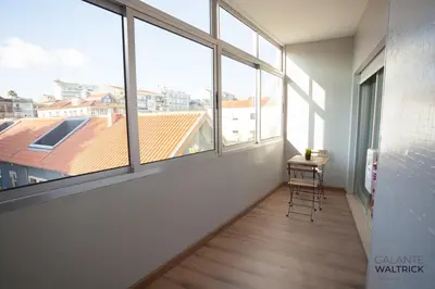 an empty room with windows and a table and chairs at Quiet 3BR Flat - City Center - Warm and Bright - Remote Work in Porto