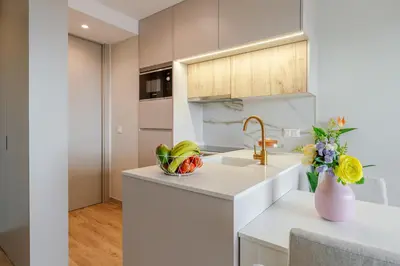 a kitchen with a sink and a vase of flowers on a counter at Modern Porto Retreat by HostWise in Vila Nova de Gaia