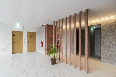 a hallway with doors and a potted plant in a building at Modern Porto Retreat by HostWise in Vila Nova de Gaia