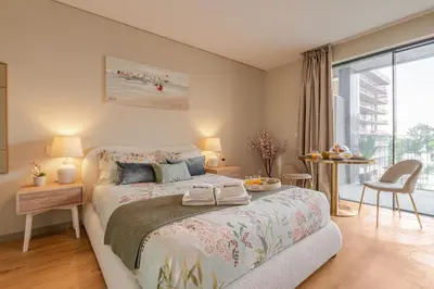 a bedroom with a bed and a table with chairs at Modern Porto Retreat by HostWise in Vila Nova de Gaia