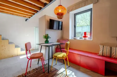 a white bedroom with a bed and a tv at Kleine's House in Porto - Mezzanine Boavista in Porto