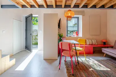 a kitchen with wooden walls and a couch in a room at Kleine's House in Porto - Mezzanine Boavista in Porto