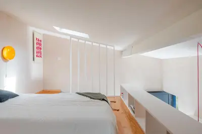 a room with a table and chairs and a couch at Kleine's House in Porto - Mezzanine Boavista in Porto