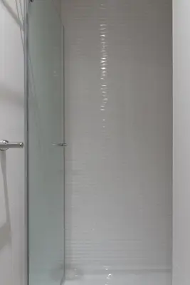 a shower with a glass door in a bathroom at Charming Flat - Garage by Host Wise in Porto