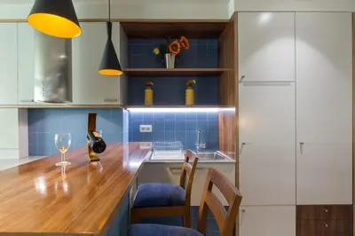 a kitchen with a counter with chairs and a table at Charming Flat - Garage by Host Wise in Porto