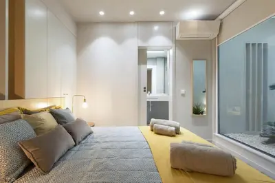 a bedroom with a large bed with two ottomans at Charming Flat - Garage by Host Wise in Porto